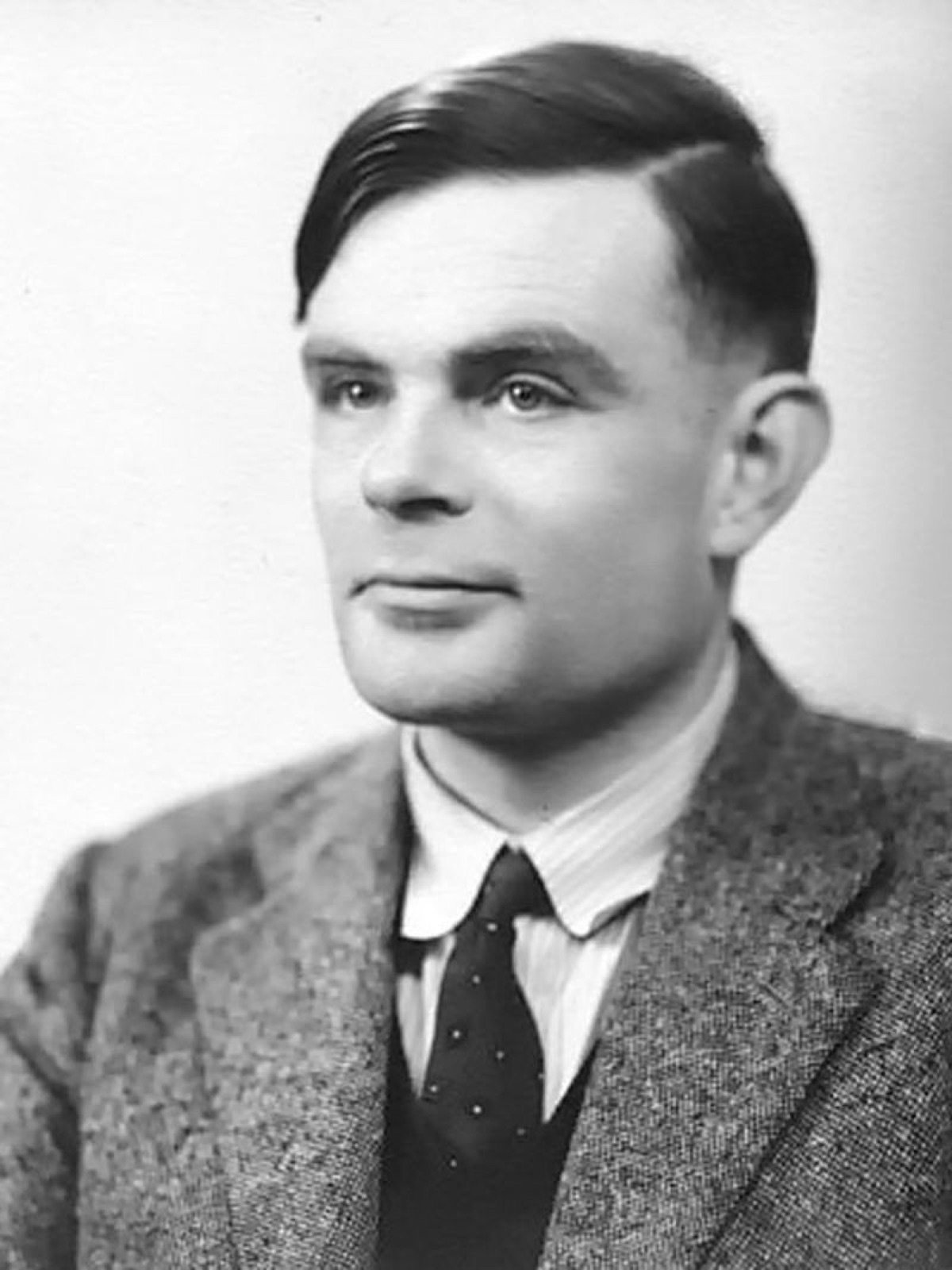 The iconic 1951 portrait of Alan Turing (1912-1954), the British mathematician and logician whose 1936 paper On Computable Numbers introduced the Turing machine and founded computer science; photograph by Elliott & Fry, public domain (via the Computer History Museum).