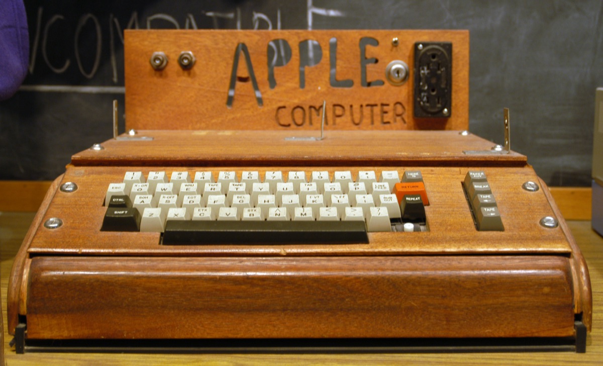 Original Apple I computer in wooden case on display at the Smithsonian, with hand-carved APPLE COMPUTER sign, 1976