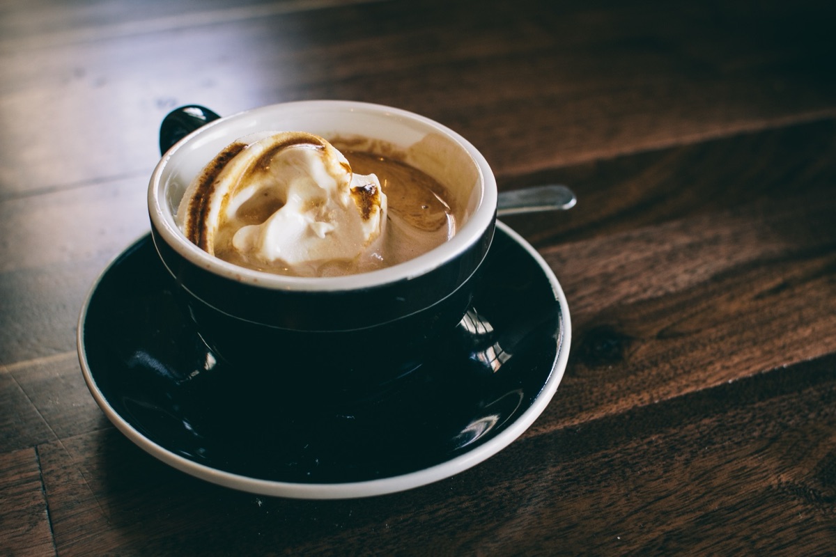 A cup of black coffee seen from above on a dark surface, illustrating the American Heart Association's 2026 statement that up to five cups of coffee a day is safe for most adults' hearts.