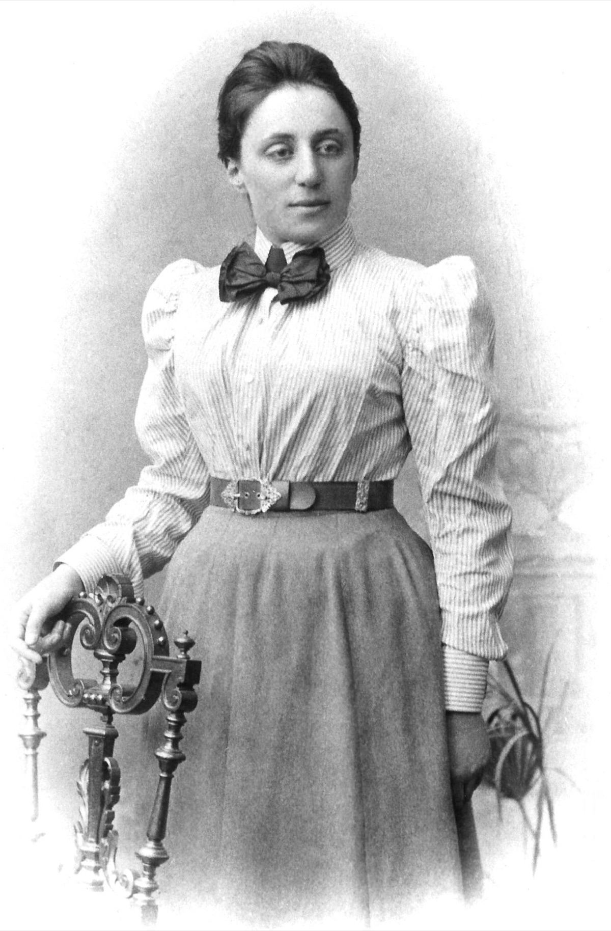 Portrait photograph of the German mathematician Emmy Noether, taken around 1900. In 1918 she proved Noether's theorem, which showed that every conservation law in physics arises from a symmetry. Public domain image (anonymous photographer) via Wikimedia Commons.